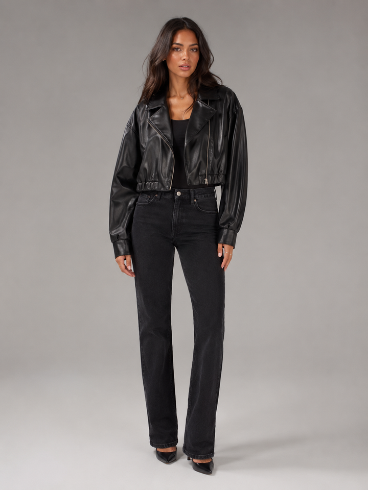Woman wearing a cropped faux leather biker jacket with notch lapels