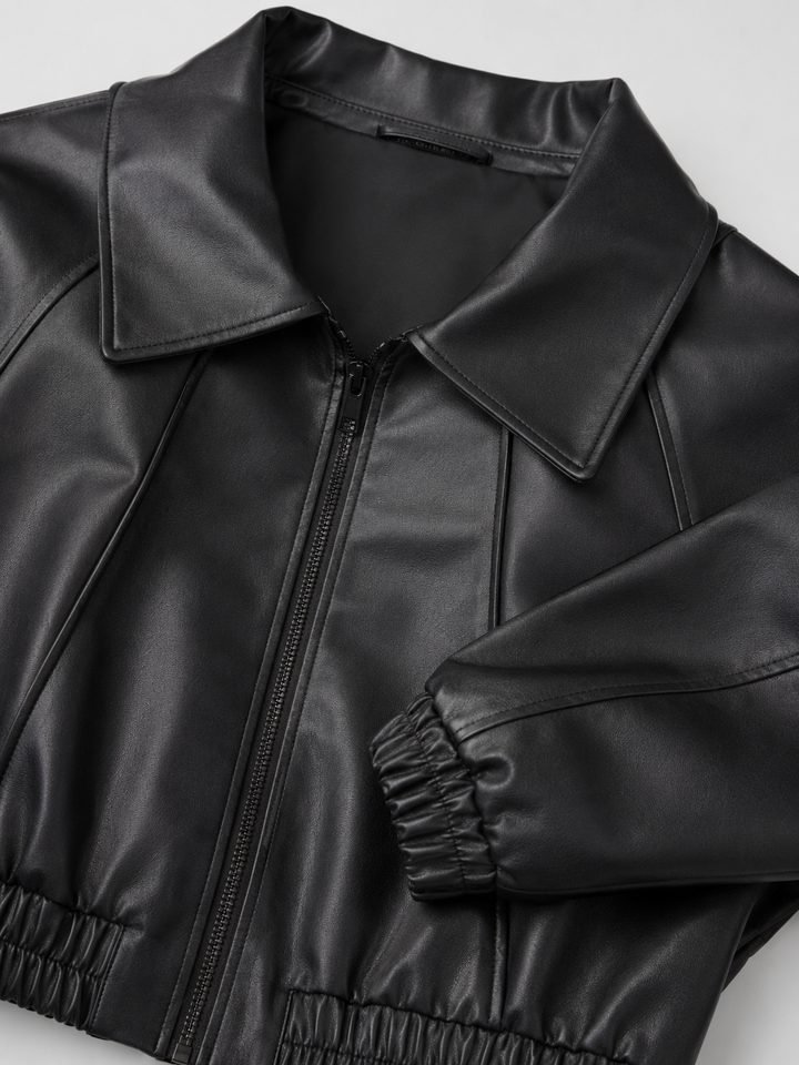 Woman wearing a cropped faux leather biker jacket with notch lapels