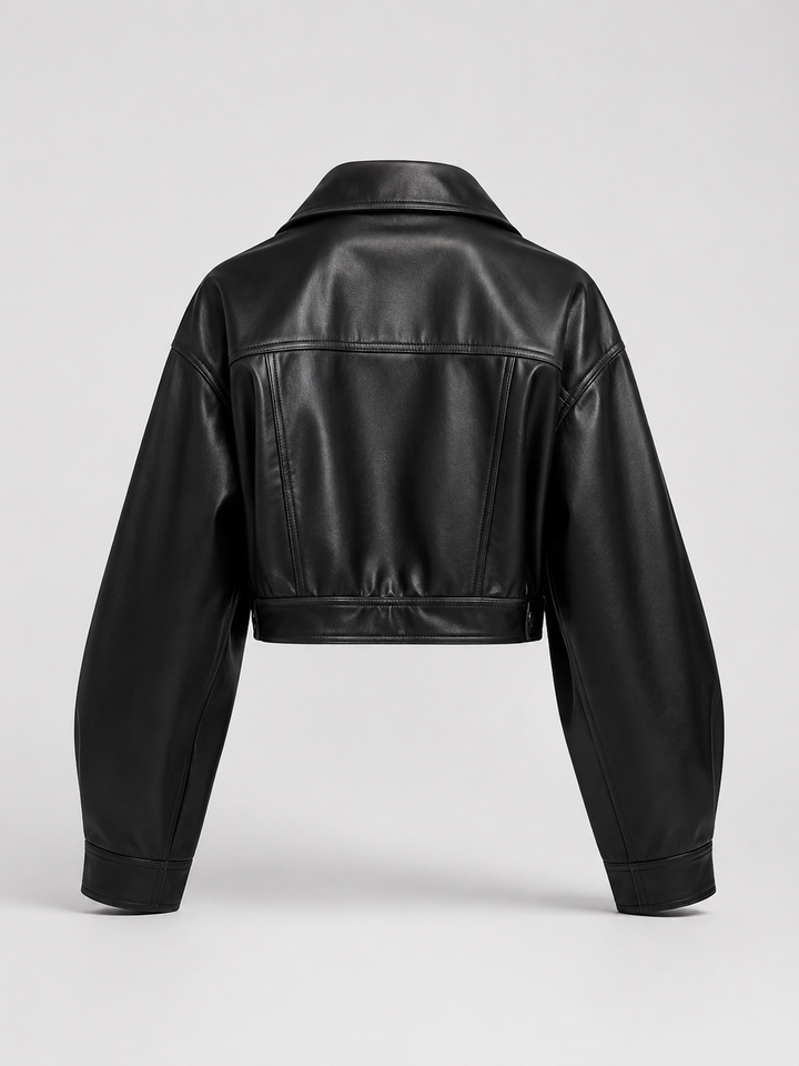 Woman wearing a cropped faux leather biker jacket with notch lapels
