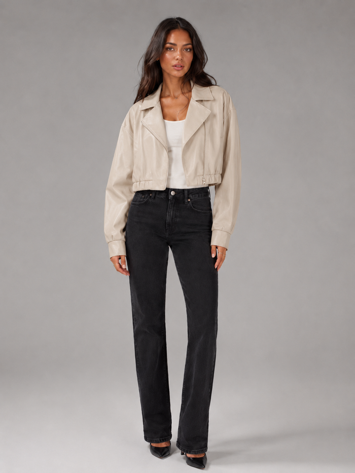 Woman wearing a cropped faux leather biker jacket with notch lapels