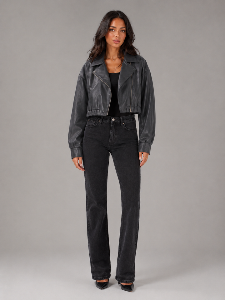 Woman wearing a cropped faux leather biker jacket with notch lapels