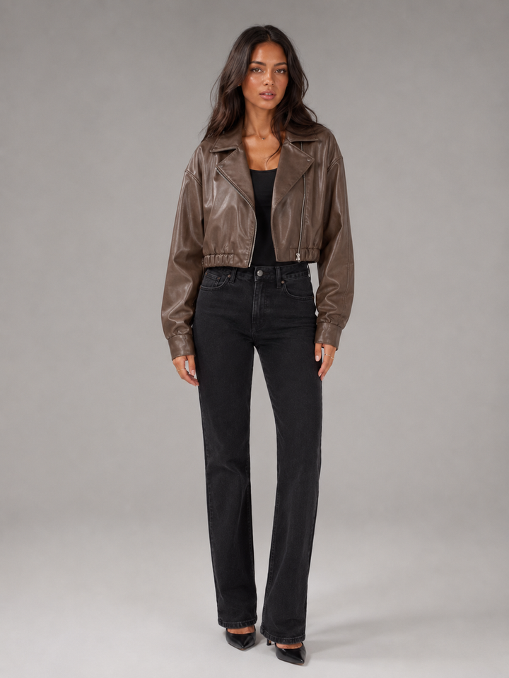Woman wearing a cropped faux leather biker jacket with notch lapels