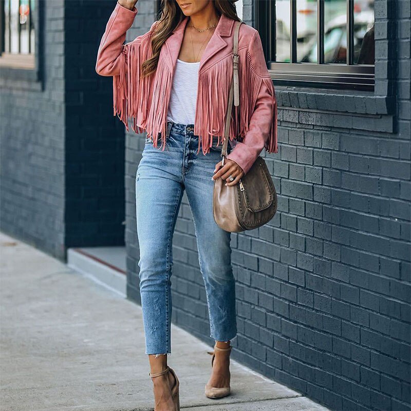 Woman wearing a fringe faux leather biker jacket with a cropped western cut
