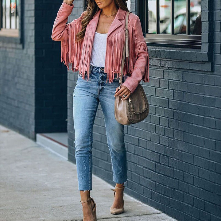 Woman wearing a fringe faux leather biker jacket with a cropped western cut