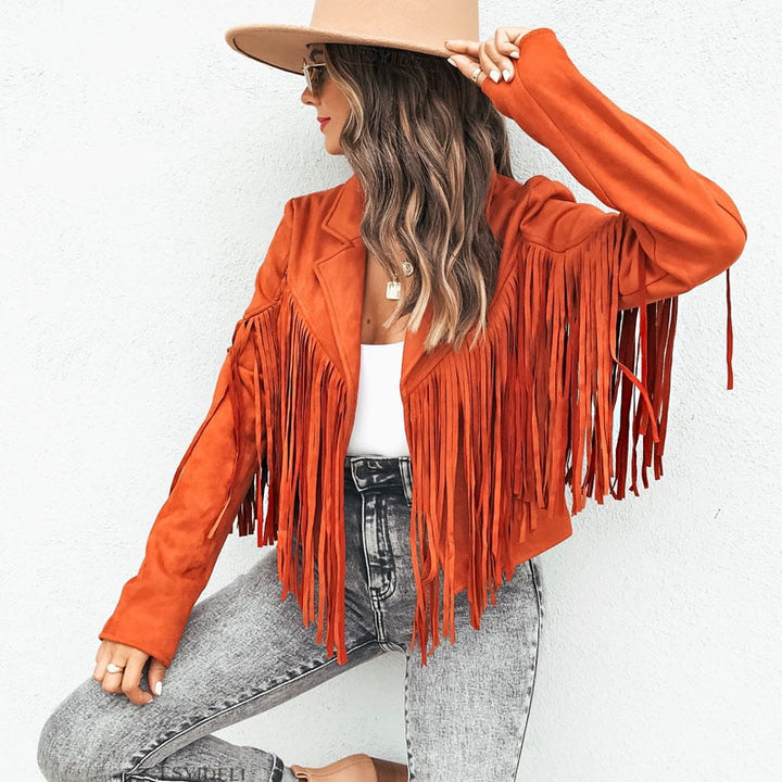 Woman wearing a fringe faux leather biker jacket with a cropped western cut