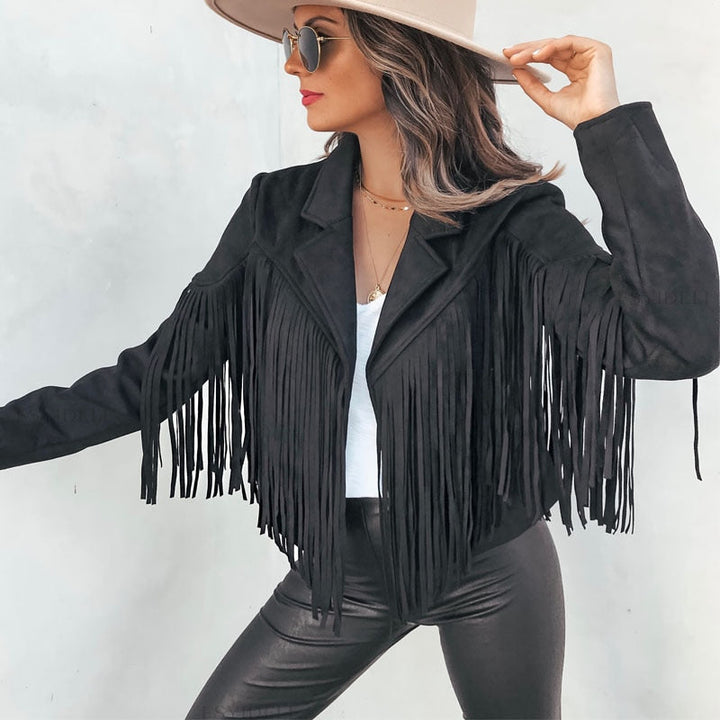 Woman wearing a fringe faux leather biker jacket with a cropped western cut