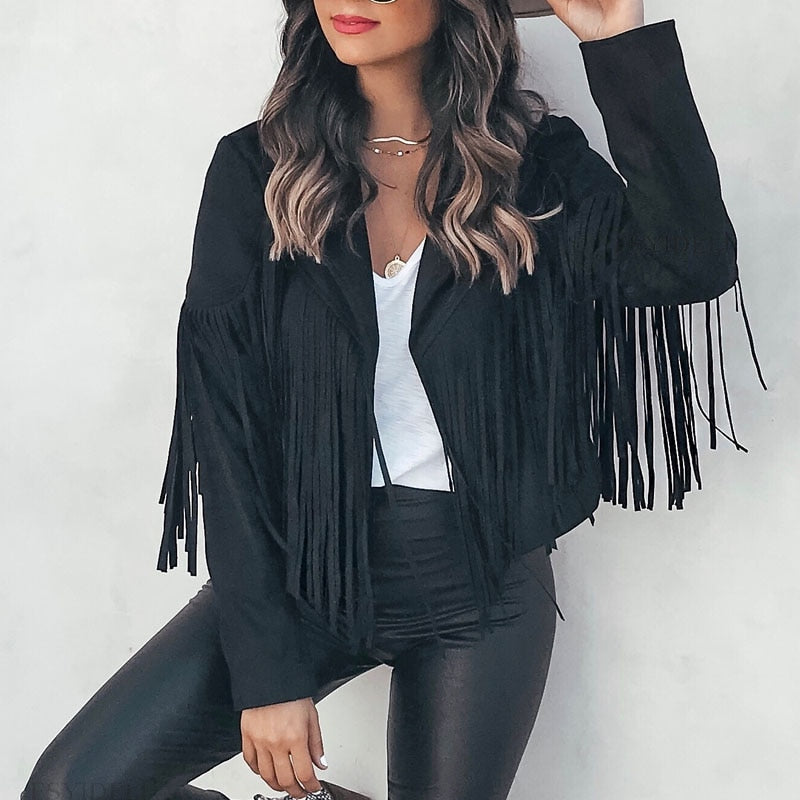 Woman wearing a fringe faux leather biker jacket with a cropped western cut