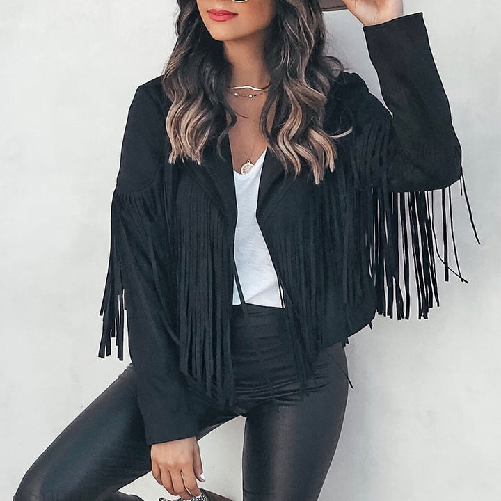Woman wearing a fringe faux leather biker jacket with a cropped western cut