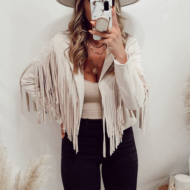 Woman wearing a fringe faux leather biker jacket with a cropped western cut
