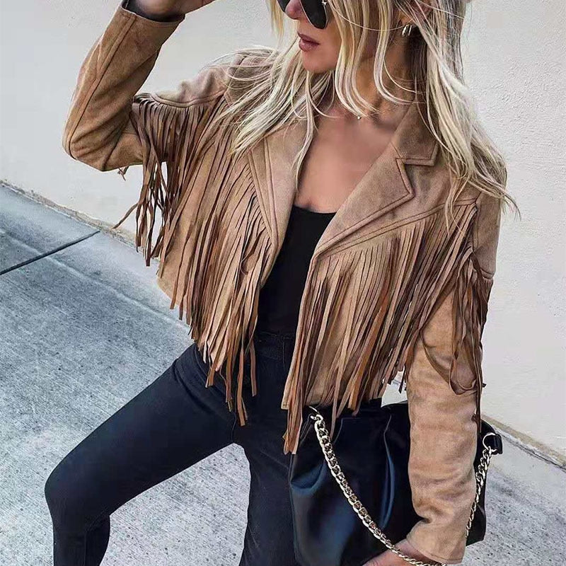 Woman wearing a fringe faux leather biker jacket with a cropped western cut