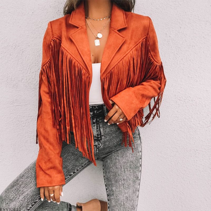 Woman wearing a fringe faux leather biker jacket with a cropped western cut
