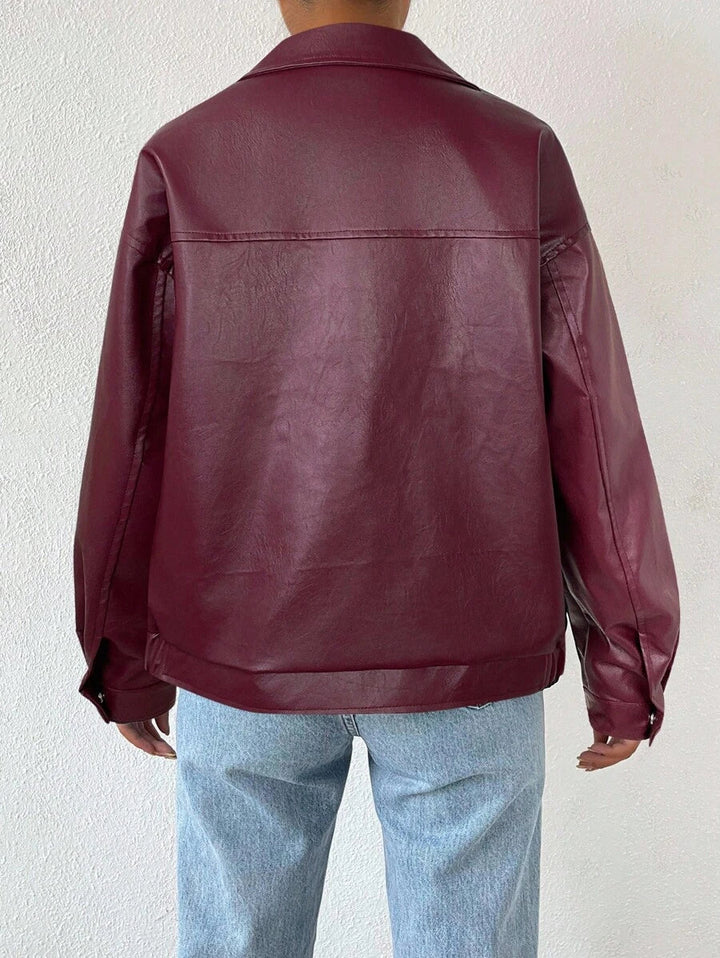 Woman wearing a slouchy oversized faux leather jacket with a dropped shoulder