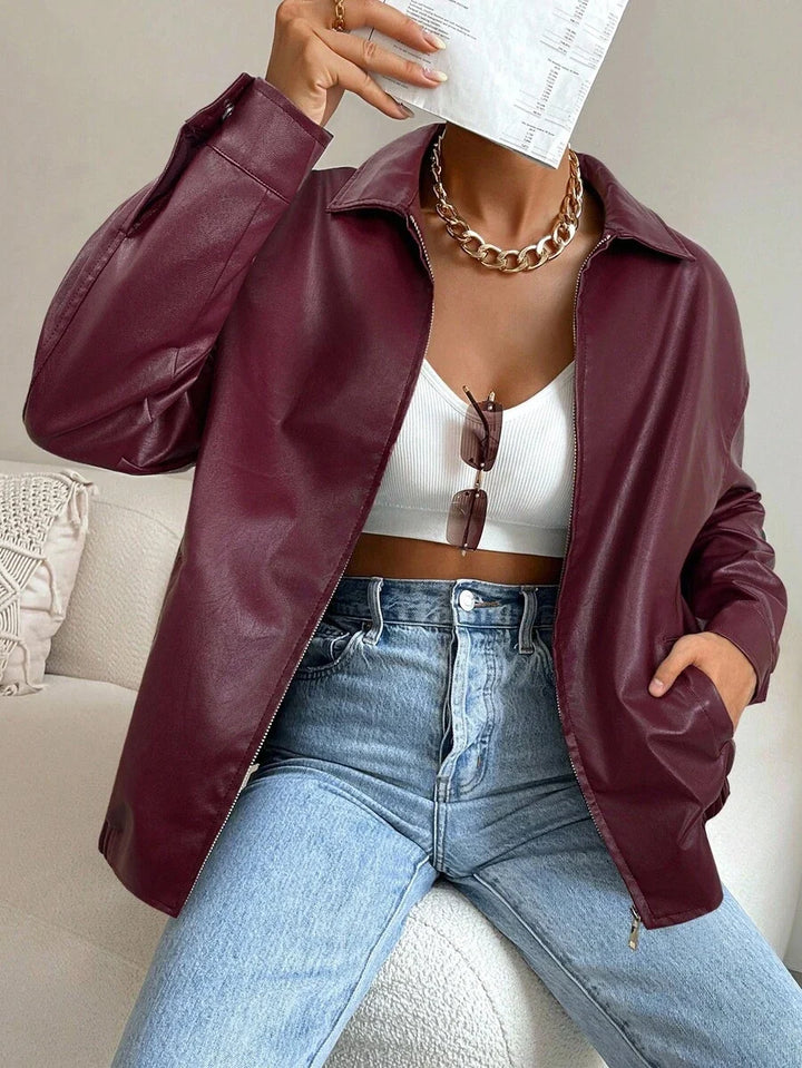 Woman wearing a slouchy oversized faux leather jacket with a dropped shoulder