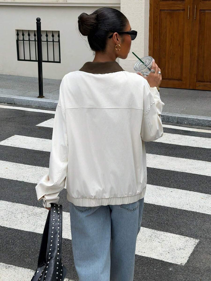 Woman wearing a slouchy oversized faux leather jacket with a dropped shoulder