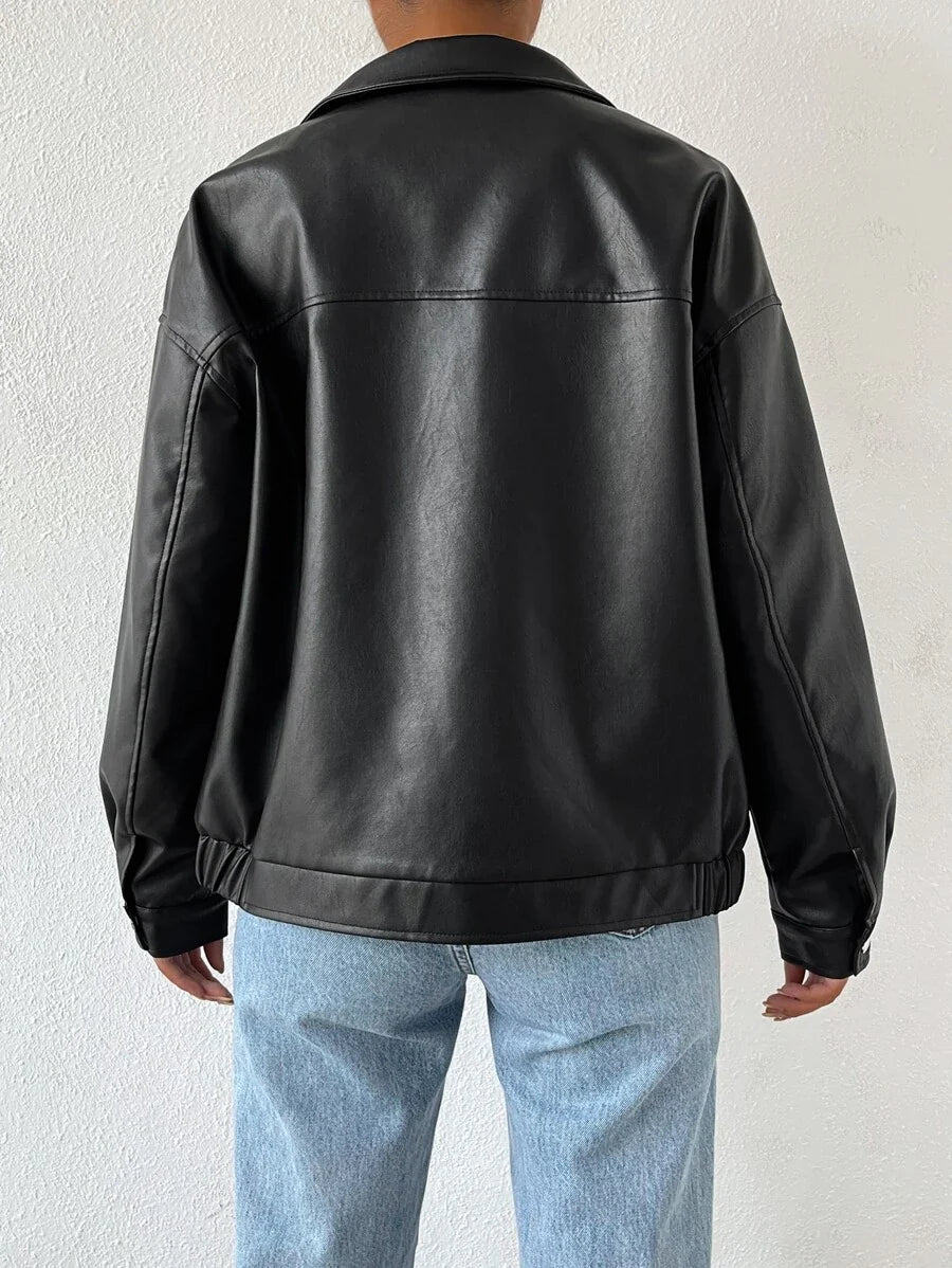 Woman wearing a slouchy oversized faux leather jacket with a dropped shoulder