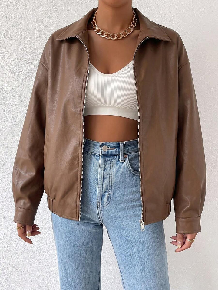 Woman wearing a slouchy oversized faux leather jacket with a dropped shoulder