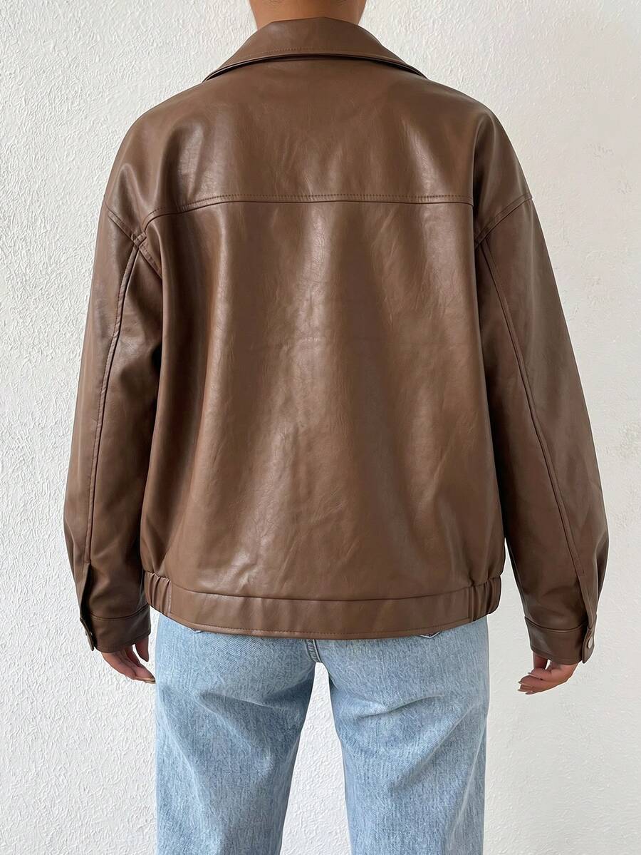 Woman wearing a slouchy oversized faux leather jacket with a dropped shoulder