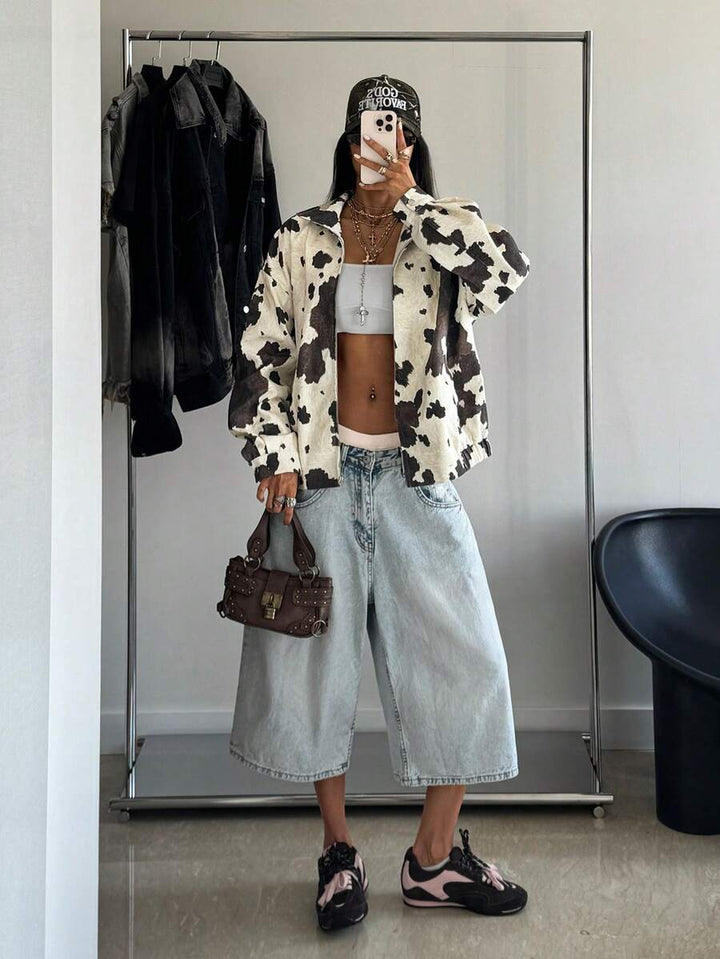 Woman wearing a slouchy oversized faux leather jacket with a dropped shoulder