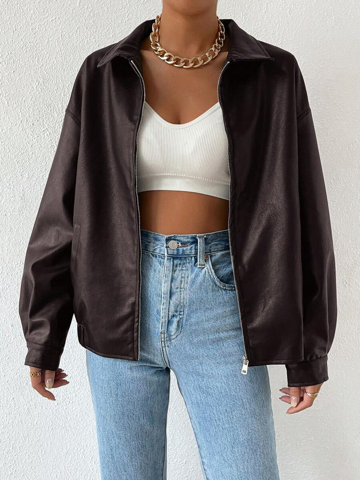 Woman wearing a slouchy oversized faux leather jacket with a dropped shoulder
