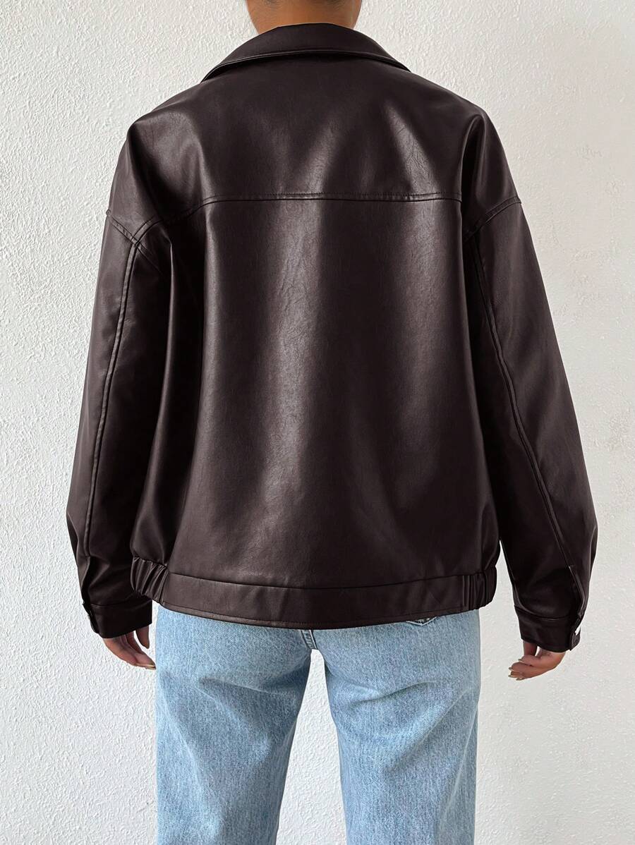 Woman wearing a slouchy oversized faux leather jacket with a dropped shoulder