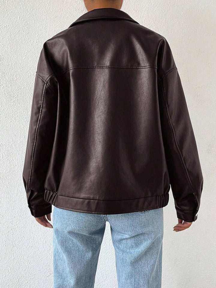 Woman wearing a slouchy oversized faux leather jacket with a dropped shoulder