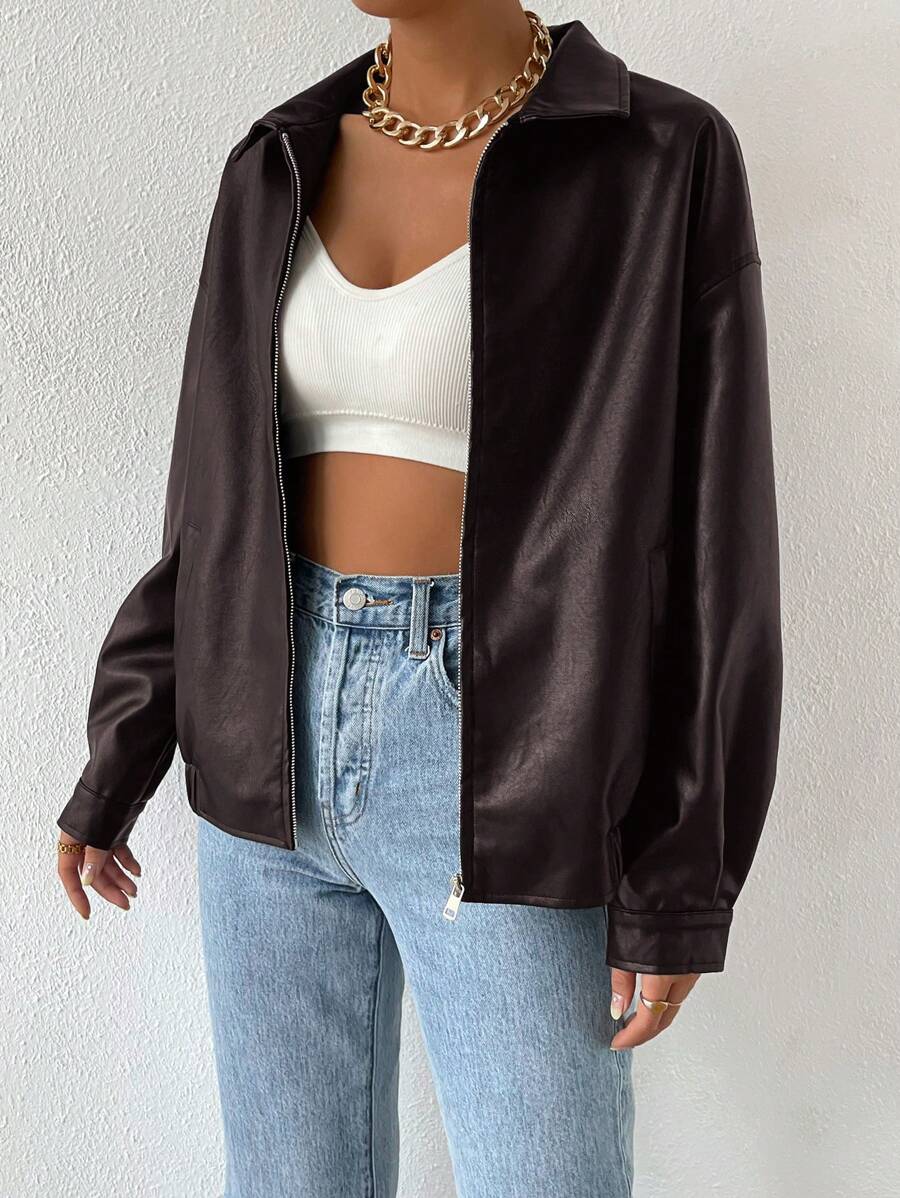 Woman wearing a slouchy oversized faux leather jacket with a dropped shoulder