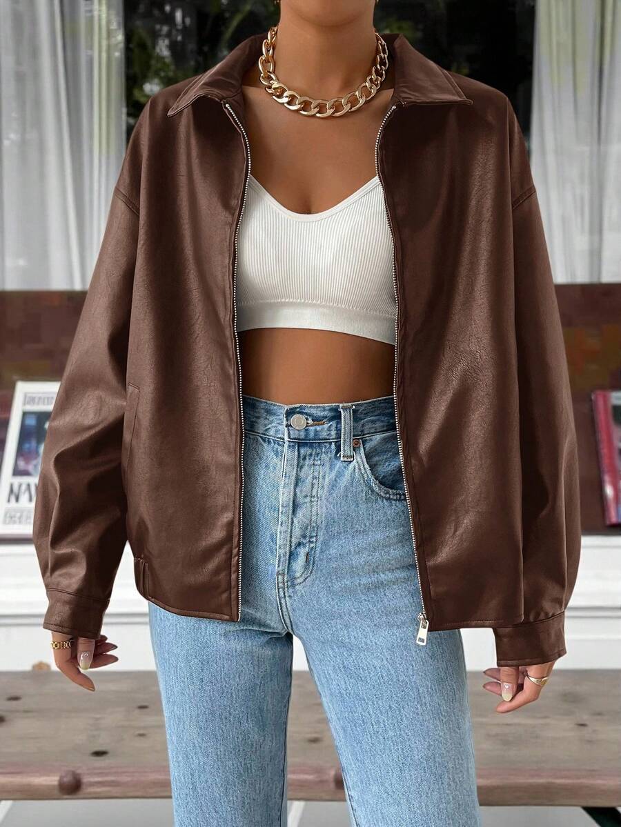 Woman wearing a slouchy oversized faux leather jacket with a dropped shoulder