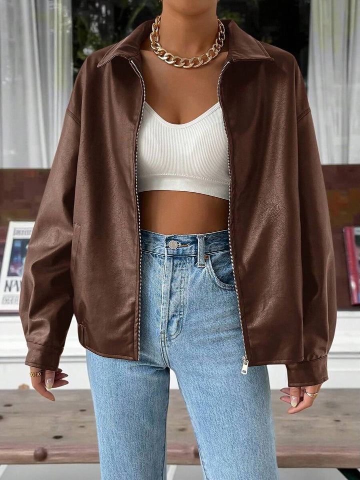 Woman wearing a slouchy oversized faux leather jacket with a dropped shoulder