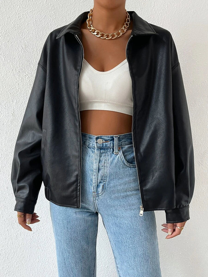 Woman wearing a slouchy oversized faux leather jacket with a dropped shoulder