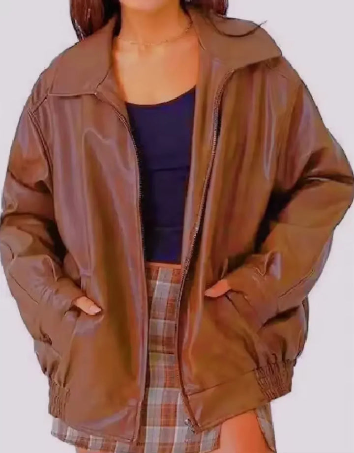 Woman wearing a boxy oversized faux leather jacket with a point collar