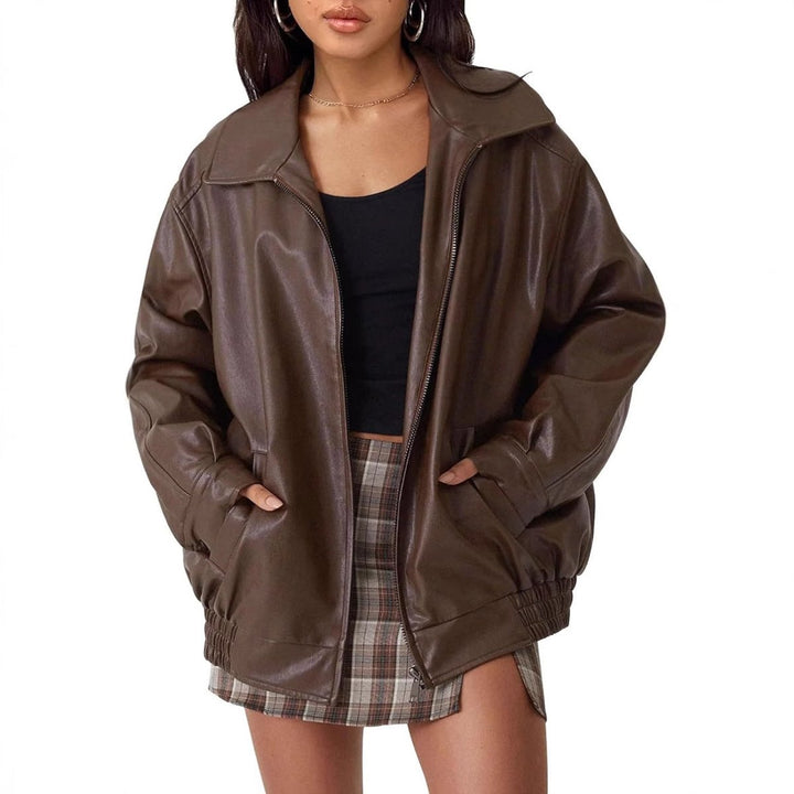 Woman wearing an oversized faux leather bomber jacket with a point collar