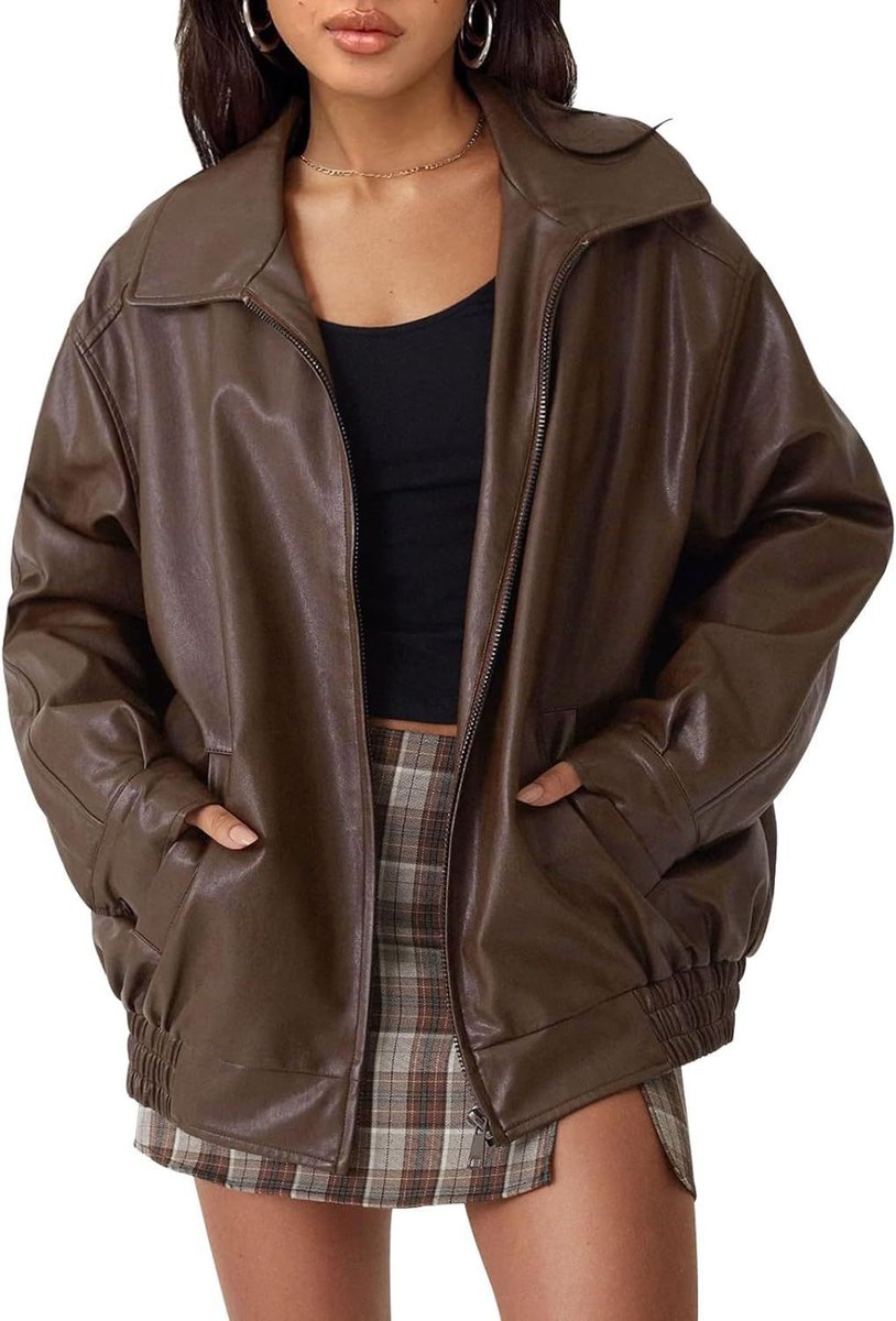 Woman wearing an oversized faux leather bomber jacket with a point collar