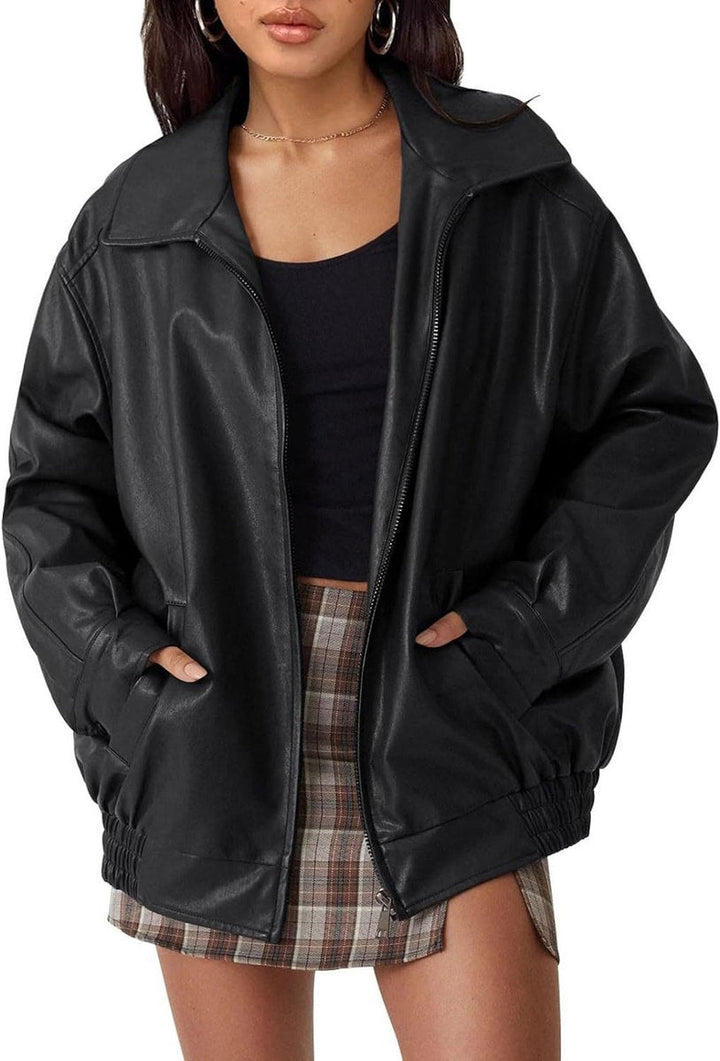 Woman wearing an oversized faux leather bomber jacket with a point collar